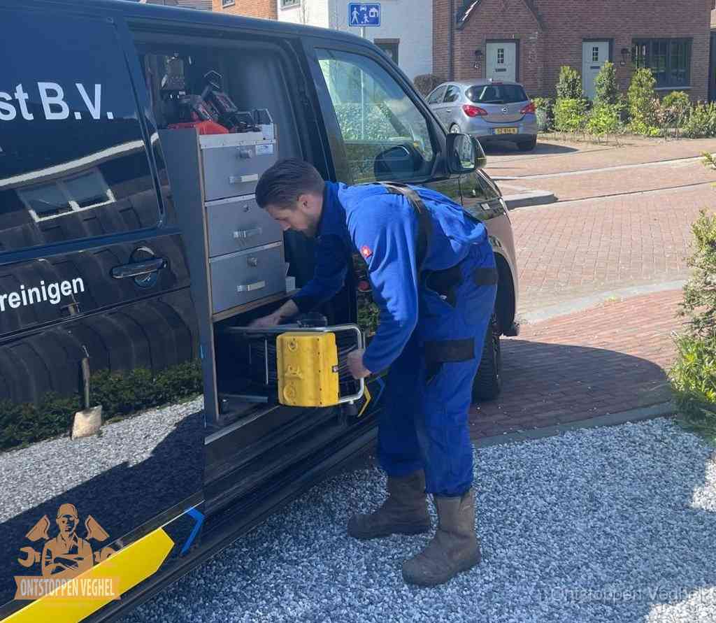 Een monteur pakt apparatuur uit de bedrijfsbus voor service aan huis, het moment om een professional in te schakelen in Veghel